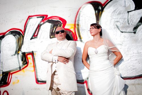 0031_Brautpaar_lehnt_an_Graffiti_Mauer_Hochzeit.jpg